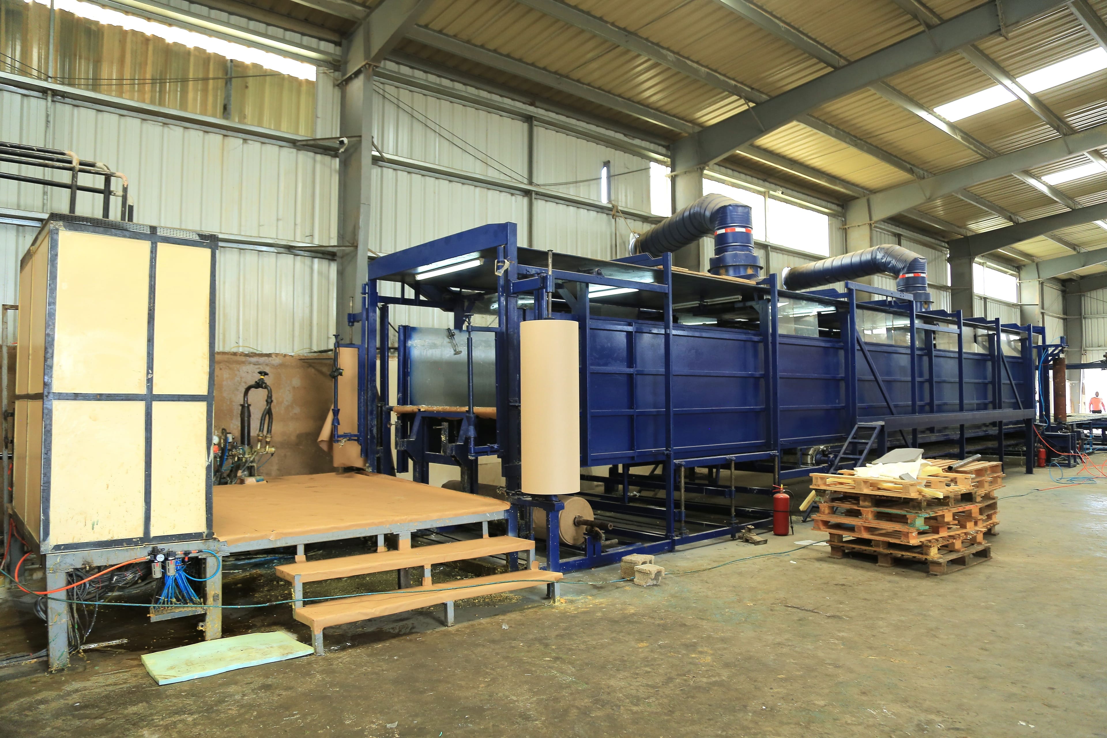 Continuous foam production line running the length of the factory floor.